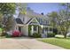 Inviting two-story home with a covered porch, beautiful bay window, a driveway, and colorful azalea bushes at 8608 Cheerful Ct, Raleigh, NC 27615