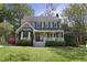 Charming two-story home featuring a well-manicured lawn, front porch, bay window, and beautiful landscaping at 8608 Cheerful Ct, Raleigh, NC 27615