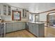 Bright kitchen with stainless steel appliances, light grey cabinets, granite countertops, and hardwood floors at 8608 Cheerful Ct, Raleigh, NC 27615