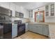 Well-lit kitchen featuring updated cabinets, appliances, granite countertops, and a window providing outdoor views at 8608 Cheerful Ct, Raleigh, NC 27615