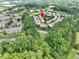 Aerial view of the neighborhood surrounded by a serene lake and lush trees, showcasing the home's location at 8722 Macedonia Lake Dr, Cary, NC 27518