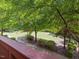 Scenic backyard view with lush greenery and mature trees, offering a peaceful and private outdoor space at 8722 Macedonia Lake Dr, Cary, NC 27518