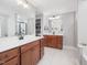 Spacious bathroom featuring double vanities, quartz countertop, and a walk-in shower with sleek fixtures at 8722 Macedonia Lake Dr, Cary, NC 27518