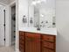 Well-organized bathroom offering double vanities and an accessible closet space for towels and storage at 8722 Macedonia Lake Dr, Cary, NC 27518