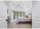 Bright and airy bedroom with tray ceiling, large windows, and neutral décor at 8722 Macedonia Lake Dr, Cary, NC 27518
