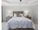 Comfortable bedroom showcasing neutral colors, a tray ceiling, and ample natural light at 8722 Macedonia Lake Dr, Cary, NC 27518