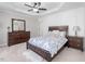 Comfortable bedroom featuring a tray ceiling, soft lighting, and coordinated furniture for a cozy ambiance at 8722 Macedonia Lake Dr, Cary, NC 27518