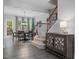 Open floor plan with stairs, a dining table with seating, and hardwood floors at 8722 Macedonia Lake Dr, Cary, NC 27518