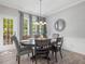 Bright dining room with hardwood floors, modern lighting, and large windows offering scenic views at 8722 Macedonia Lake Dr, Cary, NC 27518