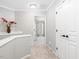 Bright upstairs hallway with carpet flooring, white trim, and bedrooms with ceiling fans at 8722 Macedonia Lake Dr, Cary, NC 27518