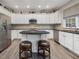 Spacious kitchen with modern appliances, granite countertops, and an island with bar seating at 8722 Macedonia Lake Dr, Cary, NC 27518