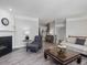 Spacious living area featuring a fireplace, comfortable seating, and hardwood flooring at 8722 Macedonia Lake Dr, Cary, NC 27518