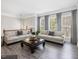 Bright living room with two sofas, a coffee table, and large windows with gray curtains at 8722 Macedonia Lake Dr, Cary, NC 27518