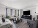 Comfortable living room with modern furnishings, large TV, and hardwood flooring at 8722 Macedonia Lake Dr, Cary, NC 27518