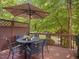 Charming outdoor deck featuring a patio set perfect for relaxing and enjoying the serene backyard at 8722 Macedonia Lake Dr, Cary, NC 27518