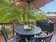 Inviting outdoor deck features comfortable seating, a patio umbrella, and grill for outdoor dining at 8722 Macedonia Lake Dr, Cary, NC 27518