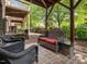 Cozy brick patio includes cushioned seating, a small table, and a beautiful yard at 8722 Macedonia Lake Dr, Cary, NC 27518