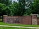 Street view of the community's sign: Tryon Village, Windsor Apartments Creekside Townhomes at 8722 Macedonia Lake Dr, Cary, NC 27518