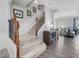 Elegant staircase with wooden handrail and decorative molding, leading to the upper level of the home at 8722 Macedonia Lake Dr, Cary, NC 27518