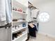 Organized walk-in closet with built-in shelves and rods, showcasing ample storage space at 8722 Macedonia Lake Dr, Cary, NC 27518