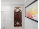 Wine cellar with an arched shelf for bottles, neutral colors, and table of varietals art at 8722 Macedonia Lake Dr, Cary, NC 27518