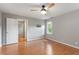 This bedroom features wood floors, a ceiling fan, and a window providing natural light at 912 Salem Woods Dr, Raleigh, NC 27615