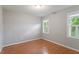 This bedroom features hardwood floors and windows for natural light at 912 Salem Woods Dr, Raleigh, NC 27615