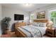 Comfortable bedroom featuring a cozy bed, wood floors, and natural light at 912 Salem Woods Dr, Raleigh, NC 27615