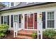 Inviting entryway with a brick landing and a red front door at 912 Salem Woods Dr, Raleigh, NC 27615