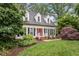 Charming home with a manicured lawn, red door, and dormer windows at 912 Salem Woods Dr, Raleigh, NC 27615