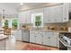 Bright kitchen with white cabinets, stainless steel appliances, and tile flooring at 912 Salem Woods Dr, Raleigh, NC 27615