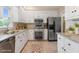 Bright kitchen with stainless steel appliances, white cabinets and granite countertops at 912 Salem Woods Dr, Raleigh, NC 27615