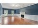 Light filled living room boasts hardwood floors, paneled walls and fireplace at 912 Salem Woods Dr, Raleigh, NC 27615
