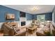 Cozy living room featuring a fireplace, blue walls, and comfortable seating at 912 Salem Woods Dr, Raleigh, NC 27615