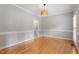 Neutral living room with hardwood floors, white crown molding, and natural lighting at 912 Salem Woods Dr, Raleigh, NC 27615