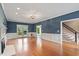 Open concept living room with hardwood floors, fireplace and staircase visible at 912 Salem Woods Dr, Raleigh, NC 27615