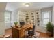 Bright home office with custom built-in shelving and a rustic wooden desk at 912 Salem Woods Dr, Raleigh, NC 27615