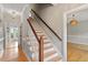Elegant foyer with a hardwood stairway and decorative lighting at 912 Salem Woods Dr, Raleigh, NC 27615