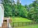 Fenced backyard with a manicured lawn, play set, and deck perfect for outdoor enjoyment at 1005 Barmkin Pl, Knightdale, NC 27545