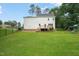 Large backyard with green lawn, bordered by a black metal fence and mature trees at 1005 Barmkin Pl, Knightdale, NC 27545