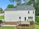Back exterior view of a house with a deck that overlooks a manicured lawn at 1005 Barmkin Pl, Knightdale, NC 27545