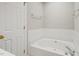 An inviting soaking tub with ceramic tile surround at 1005 Barmkin Pl, Knightdale, NC 27545