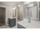 Bathroom features dual vanities, framed mirror, modern fixtures, and tiled flooring at 1005 Barmkin Pl, Knightdale, NC 27545