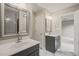 Dual sink vanity, modern fixtures, framed mirror, tile flooring, and access to bedroom at 1005 Barmkin Pl, Knightdale, NC 27545