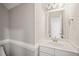 Bathroom with a single sink, white cabinets, and a large mirror at 1005 Barmkin Pl, Knightdale, NC 27545