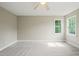 Carpeted bedroom with lots of natural light from large windows and a ceiling fan at 1005 Barmkin Pl, Knightdale, NC 27545