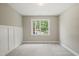 Cozy bedroom with a large window, neutral paint, and carpeted floors at 1005 Barmkin Pl, Knightdale, NC 27545
