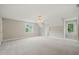 Spacious bonus room featuring neutral paint, carpet, windows and a ceiling fan at 1005 Barmkin Pl, Knightdale, NC 27545