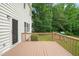 Well-maintained wooden deck featuring brown stain, leading out to a grassy backyard at 1005 Barmkin Pl, Knightdale, NC 27545