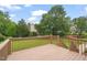 A stained wooden deck looks out over a lush, green backyard with mature trees at 1005 Barmkin Pl, Knightdale, NC 27545